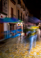 Swiftly from the rain, at night, Granada
